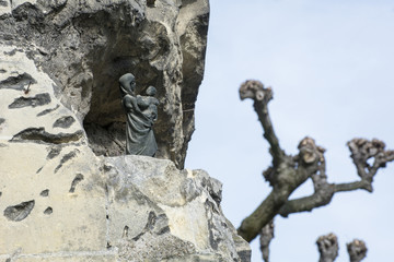 Ancient religious figurine in the stone wall