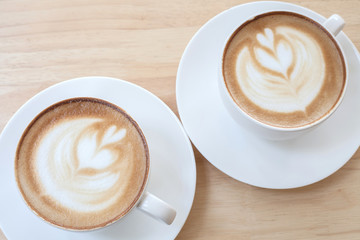 Hot art Latte Coffee in a cup on wooden table