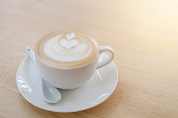 Hot art Latte Coffee in a cup on wooden table