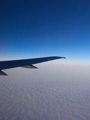 Sky and cloud as seen through window of an aircraft