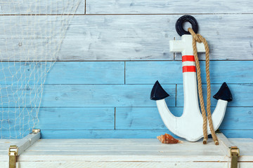 anchor on wood background blue and white © monochromst