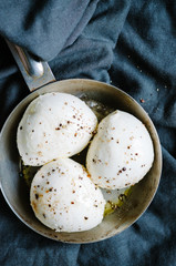mozzarella balls on a old rustic metal pan