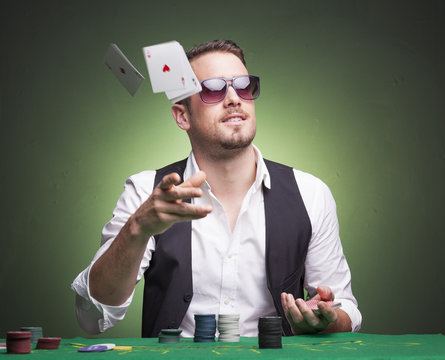 Poker player throwing cards at the table