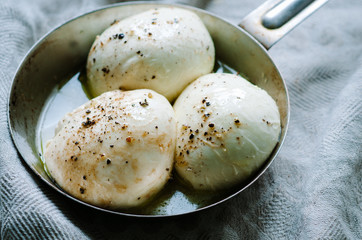 mozzarella balls on a old rustic metal pan