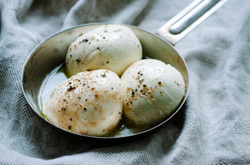 mozzarella balls on a old rustic metal pan