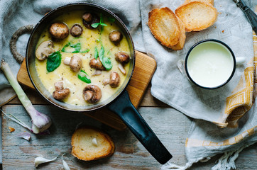 Melting mozzarella in pan with mushrooms, basil and garlic croutons