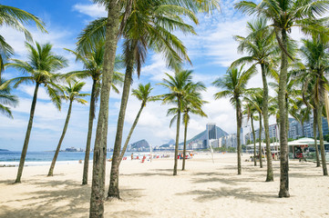 Naklejka na ściany i meble Scenic view of Copacabana Beach through palm trees from the Leme neighborhood in Rio de Janeiro, Brazil