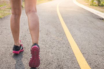 closeup of feet for woman runner athlete  running on the road or street. Healthy lifestyle concept.