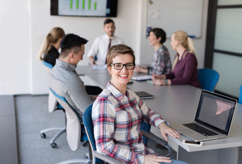 young business woman at office working on laptop with team on me