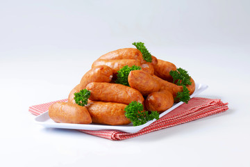 Pile of Polish sausages on plate