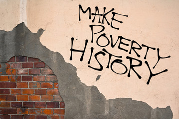 Handwritten graffiti Make Poverty History sprayed on the wall, anarchist aesthetics. Appeal to solve situation of poverty, economy and suffering in poor third world by progress, support  and aid
