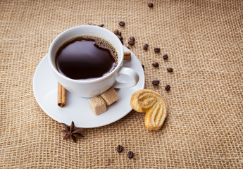 Cup of coffee, cookie on sackcloth background