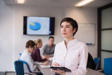 hispanic businesswoman with tablet at meeting room