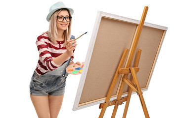 Young woman painting on a canvas