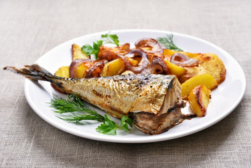 Fried mackerel fish with potato wedges