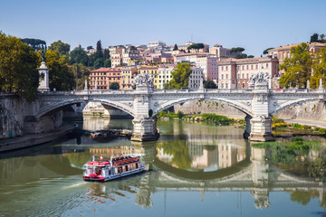 Fototapeta na wymiar Touristic boat and Ponte Vittorio Emanuele II