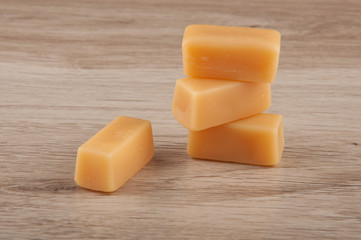 caramel candies on wooden table background