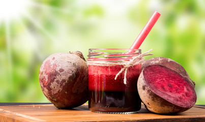 Fresh beetroot smoothie in the glass on black stone. Juice drink. Lifestyle concept