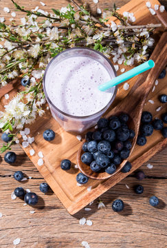 Fresh milk, blueberry drink on wooden table, assorted protein cocktail with fresh fruits. 