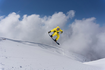 Snowboard rider jumping on mountains. Extreme snowboard freeride sport.