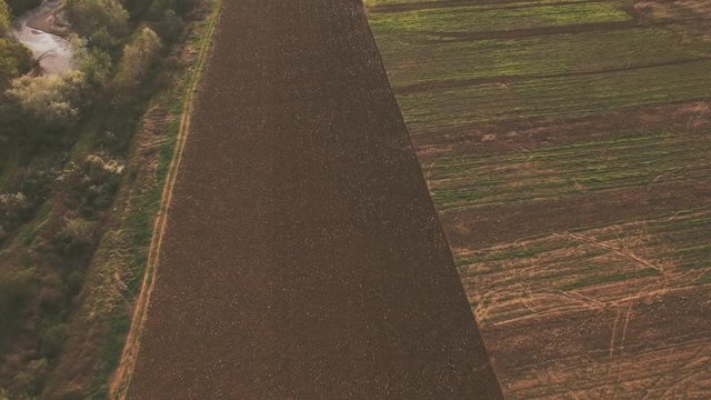 aerial video of tractor plowing a field