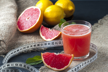 Grapefruit juice and measuring tape