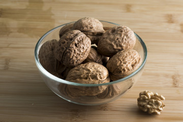 pile of walnuts in the foreground represent a healthy diet