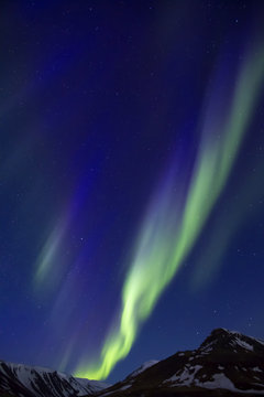 Northern Lights above mountains edge