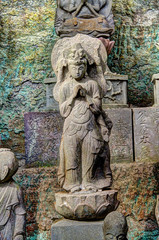 Ancient carving of a Buddas on the side of Mount Nokogiri.