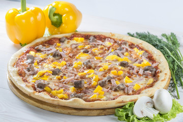 tasty pizza on a wooden board with pepper and mushrooms