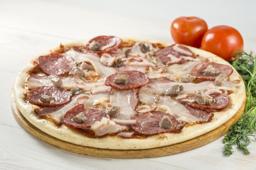 delicious pizza on wooden board with tomato and dill