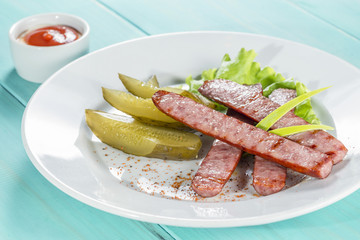 hunting sausage of beef with pickled cucumber