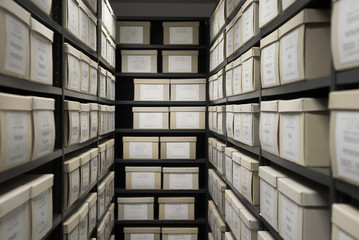 Fototapeta Indoor storage details in a manufacturing enterprise, black shelves with white office boxes.  obraz