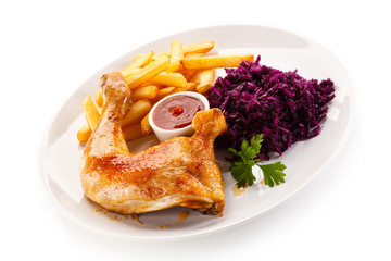 Roast chicken legs with chips and vegetables