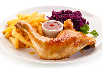 Roast chicken legs with chips and vegetables