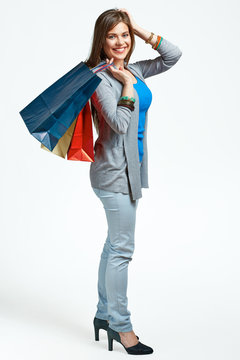 full body portrait of young woman with shopping bags.