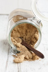 whole brown sugar cane spilling from a glass jar