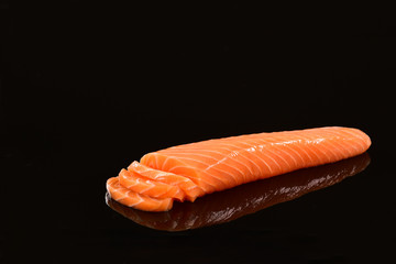 Fresh salmon fillet on black blackground