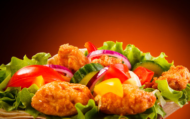 Chicken nuggets and vegetables in tortilla wrap