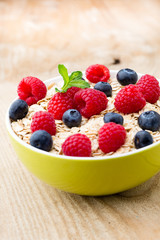 Oatmeal porridge with berries. Raspberries and blueberries.