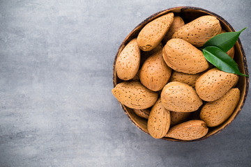 Group of almond nuts with leaves.Wooden background.
