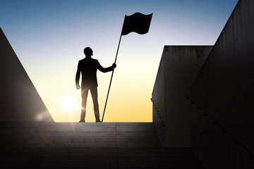 silhouette of businessman with flag over sun light