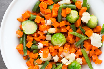 Fresh vegetables mix in a white bowl.