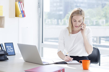 Beautiful young business woman in office