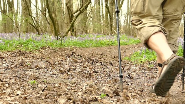 Feets of  Man hiker  in  spring wood. Healthy lifestyle. Slow motion at 100 FPS