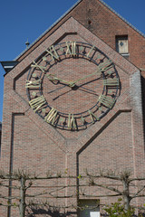Lier, Belgium. Clockwork on the side facade of the city library, former clock face of the Saint Gummarus church.