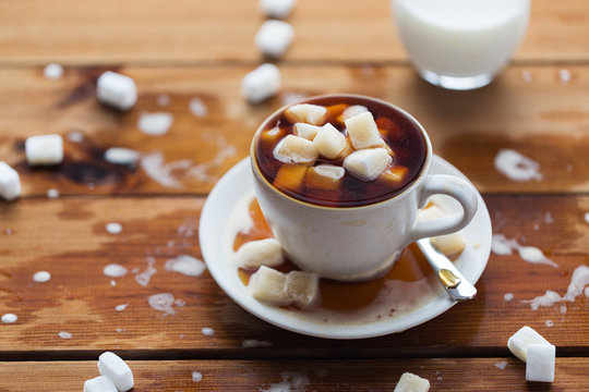 close up of sugar in coffee cup on wooden table