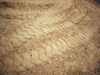 Wheel tracks on the soil.