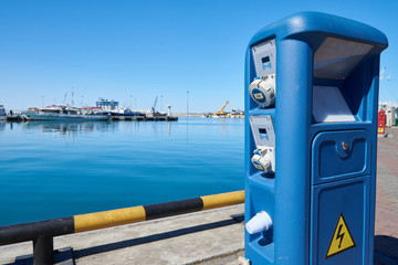 Fototapeta na wymiar Column with electrical power for yachts and boats on docks