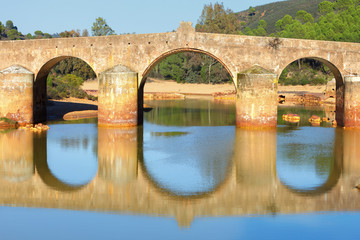 Fototapeta premium Old bridge in San Rafael on the Odiel river, Spain